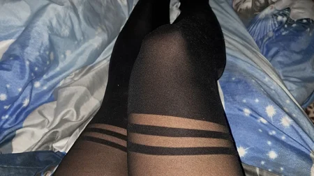 Man in black nylon tights posing sexy on the sofa