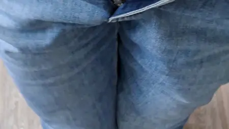 The guy takes off his jeans and shows off the control-top pantyhose underneath