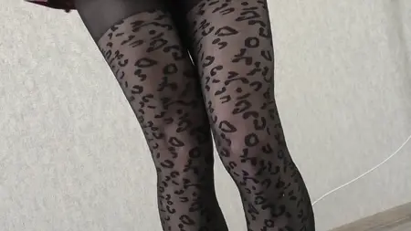 Slender crossdresser wearing black leopard pantyhose poses sexy and masturbates cock till orgasm